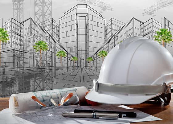 Architectural sketch, blueprints, and a hard hat on a desk